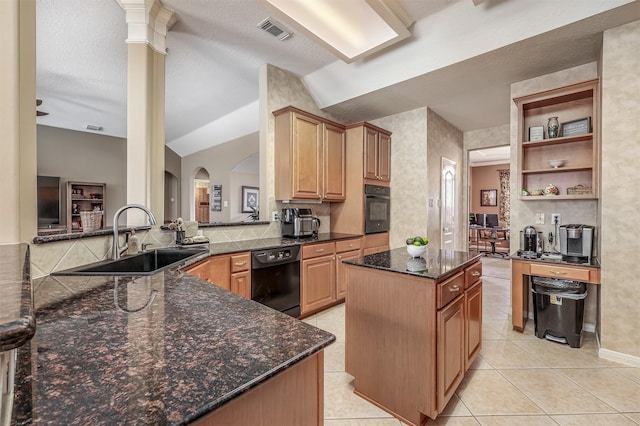 kitchen with lofted ceiling, black appliances, sink, ornate columns, and kitchen peninsula