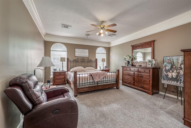 carpeted bedroom featuring multiple windows, a textured ceiling, ceiling fan, and crown molding