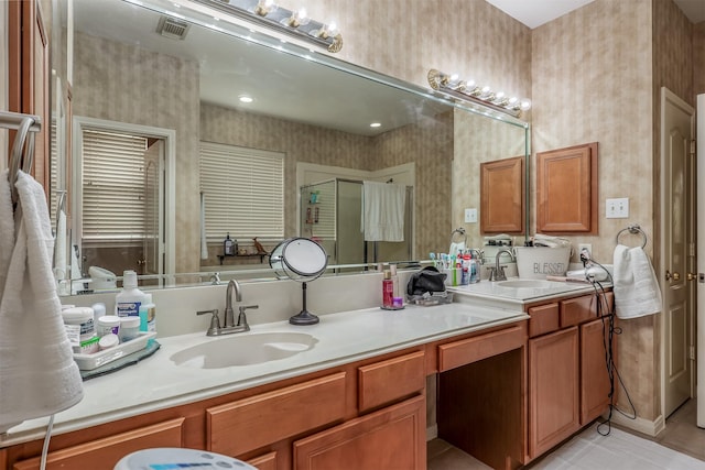 bathroom with tile patterned flooring, vanity, and walk in shower