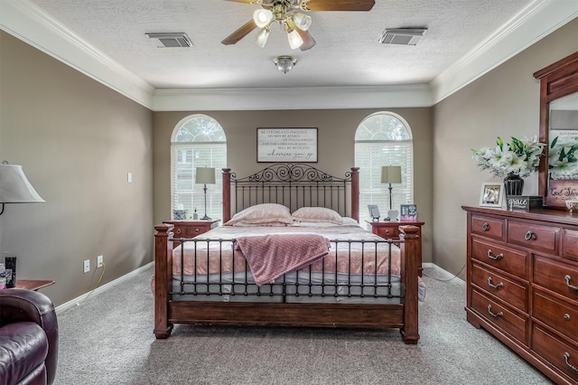 bedroom featuring light carpet, a textured ceiling, ceiling fan, and crown molding