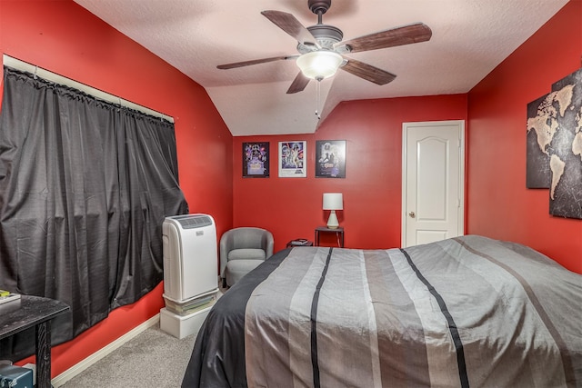 bedroom featuring lofted ceiling, ceiling fan, carpet floors, and a textured ceiling