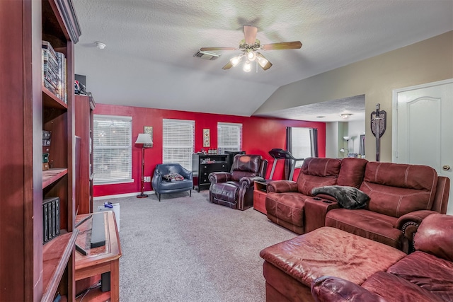 living room featuring a textured ceiling, ceiling fan, lofted ceiling, and carpet floors