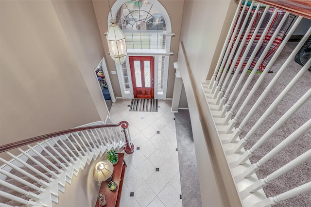 entrance foyer with a chandelier and a towering ceiling