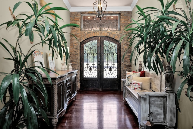 entrance foyer with dark hardwood / wood-style floors, ornamental molding, and french doors