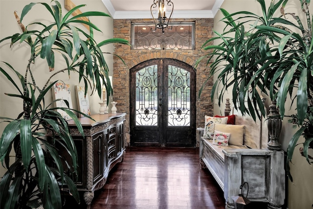 foyer entrance featuring dark wood-style floors, french doors, and crown molding