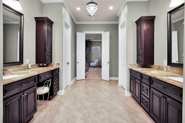 bathroom featuring crown molding, vanity, and a chandelier