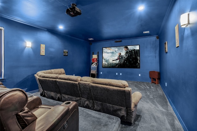 cinema room with ornamental molding, carpet, and baseboards