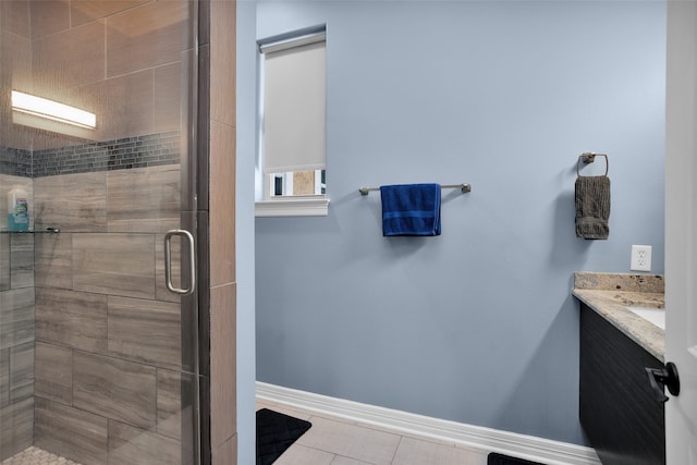 bathroom with vanity, a shower with shower door, and tile patterned flooring