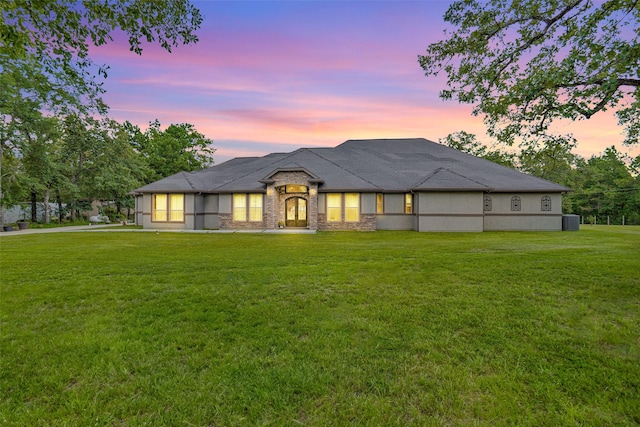 view of front of house with stone siding and a front yard