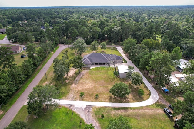 birds eye view of property featuring a view of trees