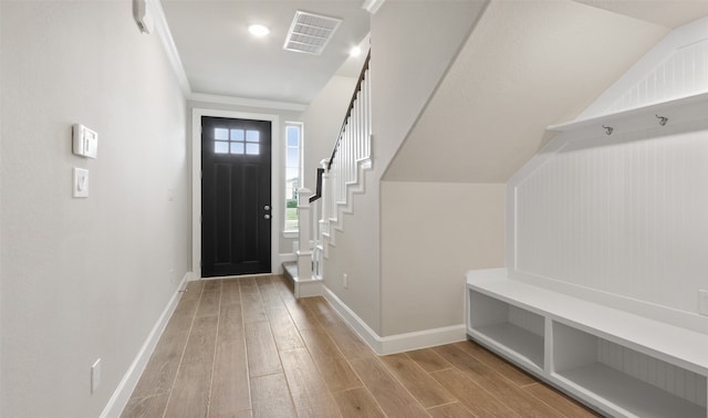 mudroom with crown molding and light hardwood / wood-style flooring