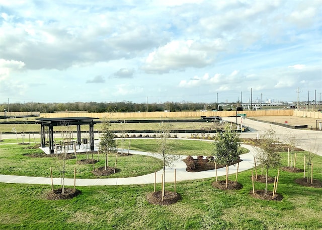 view of community featuring a rural view and a yard