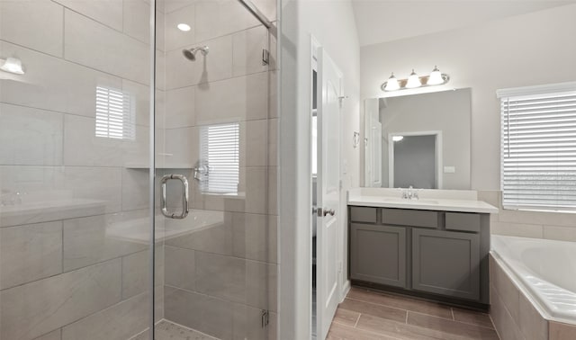 bathroom with plus walk in shower and vanity