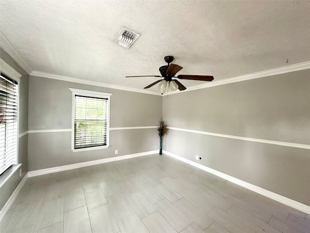 spare room featuring ceiling fan, crown molding, and a textured ceiling