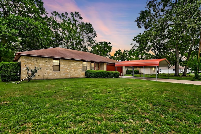 single story home featuring a yard and a carport