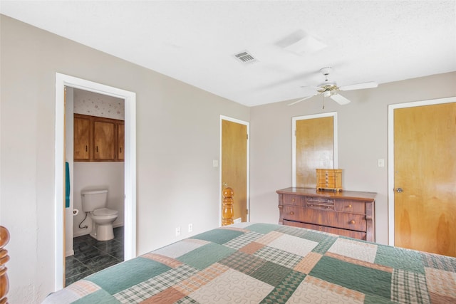 tiled bedroom featuring ceiling fan and ensuite bathroom