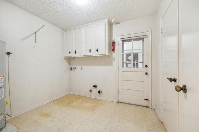 laundry area featuring a textured ceiling, gas dryer hookup, cabinets, and gas water heater