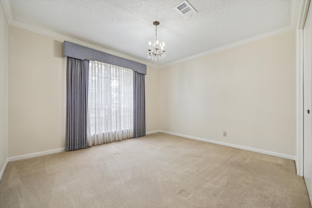 carpeted empty room featuring ornamental molding, a textured ceiling, and a notable chandelier