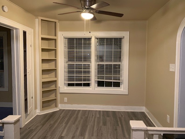 spare room with ceiling fan and dark hardwood / wood-style floors