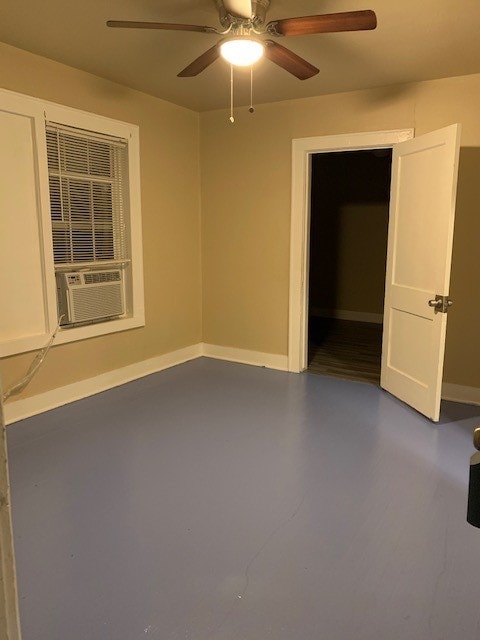 empty room featuring ceiling fan, cooling unit, and concrete floors