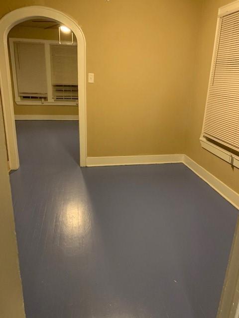 3205 Illinois St, Baytown, TX 77520 - empty room with arched walkways and baseboards