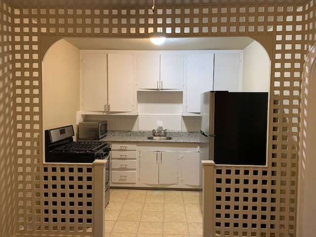 kitchen with white cabinets, stainless steel appliances, and sink