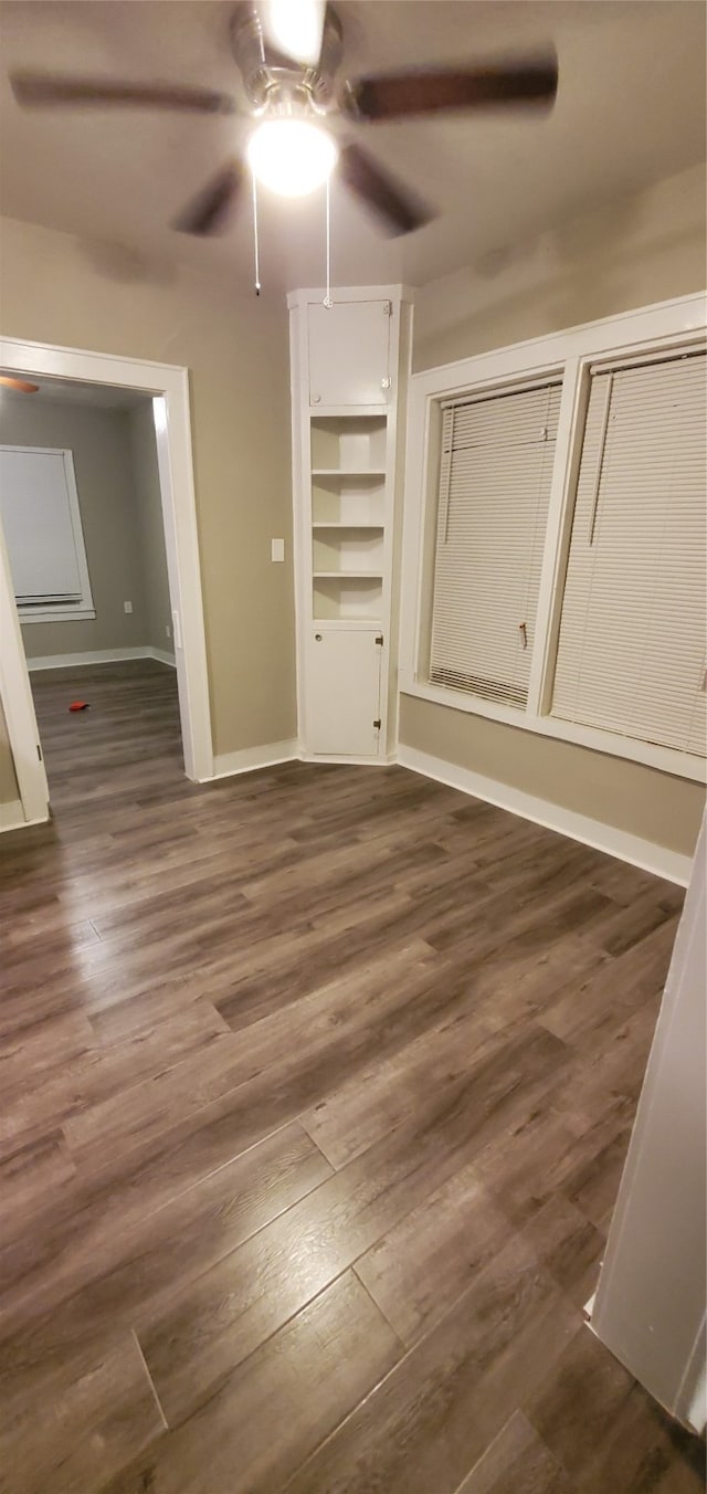 unfurnished bedroom with dark hardwood / wood-style flooring and ceiling fan