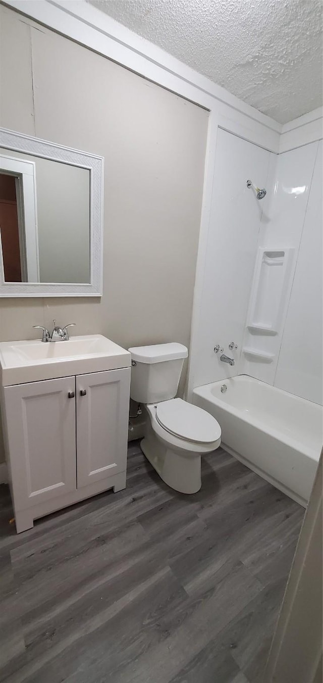 3205 Illinois St, Baytown, TX 77520 - full bath featuring vanity, a textured ceiling, wood finished floors, and shower / bath combination