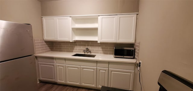 3205 Illinois St, Baytown, TX 77520 - kitchen with stainless steel appliances, open shelves, decorative backsplash, and white cabinets