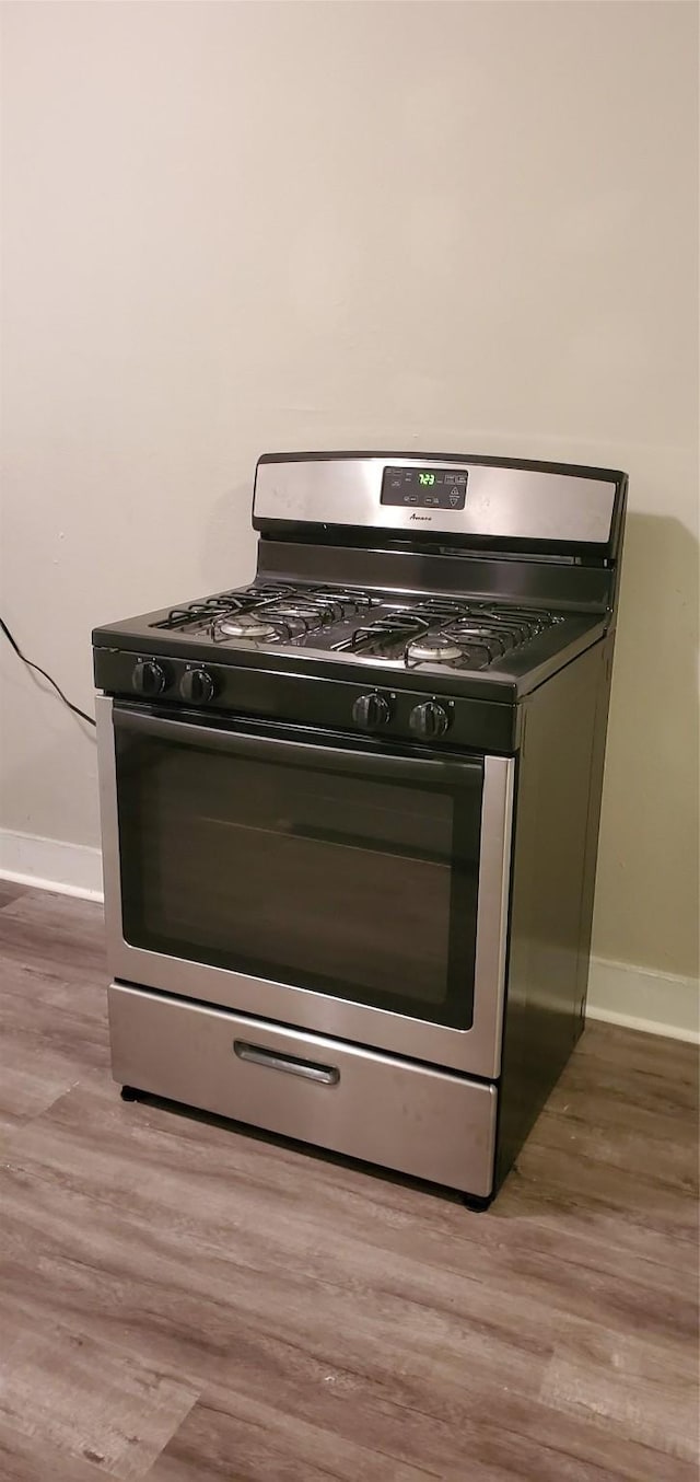 3205 Illinois St, Baytown, TX 77520 - kitchen view of stainless steel gas range oven and wood finished floors