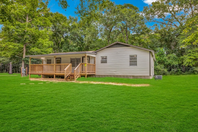 back of house featuring a yard and a deck