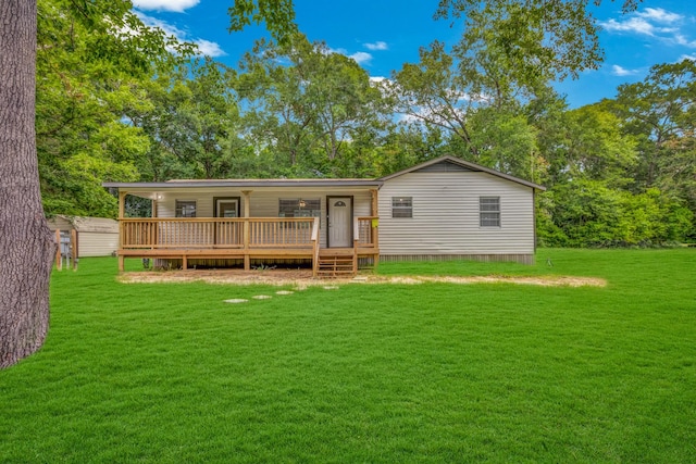 back of property with a wooden deck and a lawn