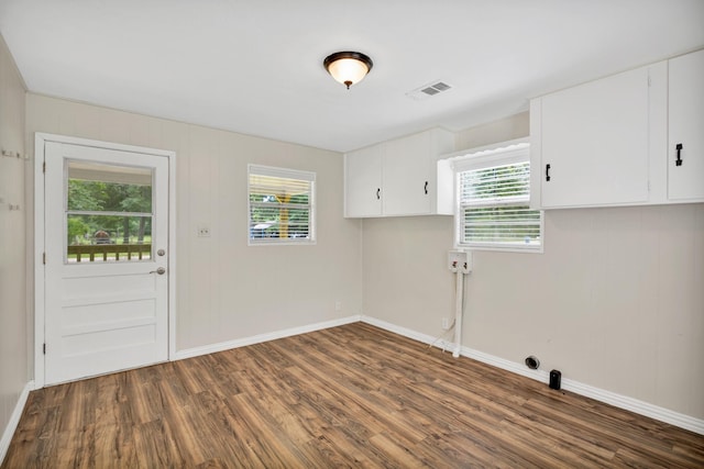 laundry room with cabinets and dark hardwood / wood-style flooring