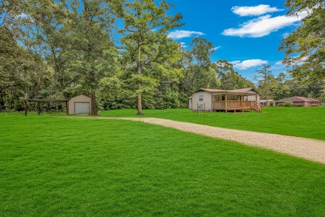 view of yard with a deck and a storage unit