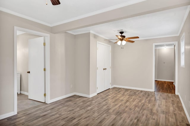 spare room with crown molding, wood-type flooring, and ceiling fan