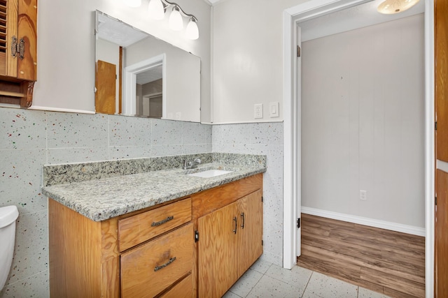 bathroom featuring vanity, backsplash, tile patterned floors, and toilet