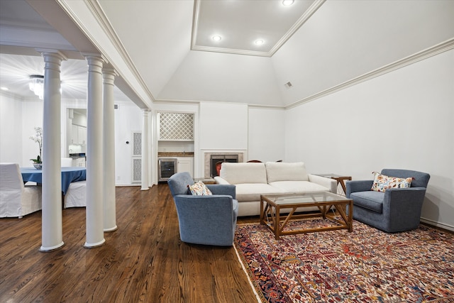 living room with a fireplace, high vaulted ceiling, ornamental molding, decorative columns, and dark hardwood / wood-style floors