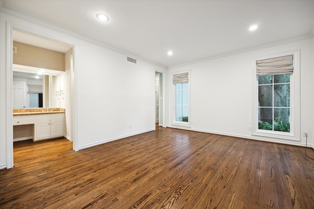 interior space featuring ornamental molding and dark wood-type flooring