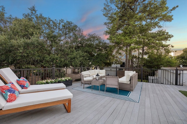 deck at dusk with an outdoor hangout area