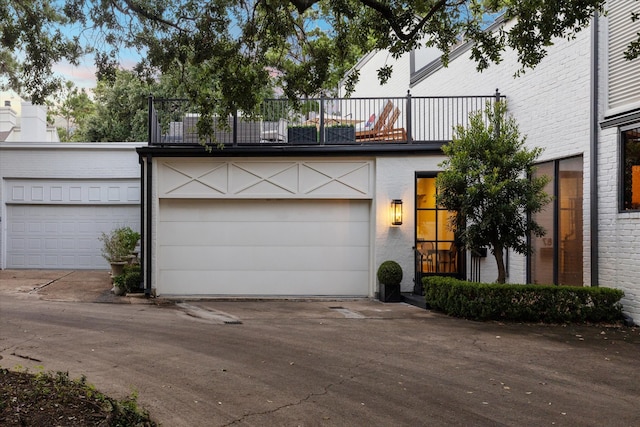 view of front of house featuring a balcony and a garage