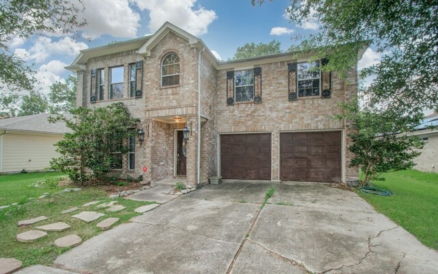 view of front of property featuring a garage and a front lawn