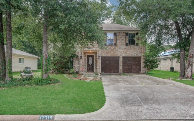 view of front of home with a front lawn and a garage