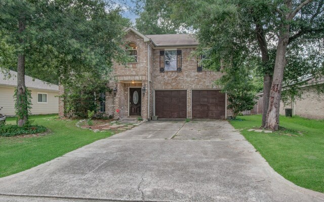 view of front of property featuring a garage and a front lawn