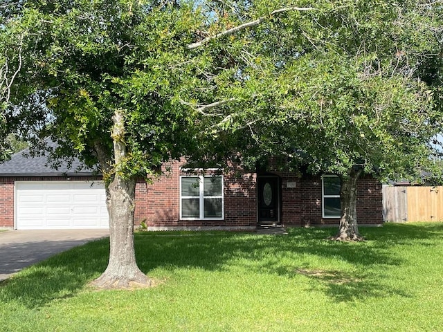 view of front of house with a garage and a front lawn