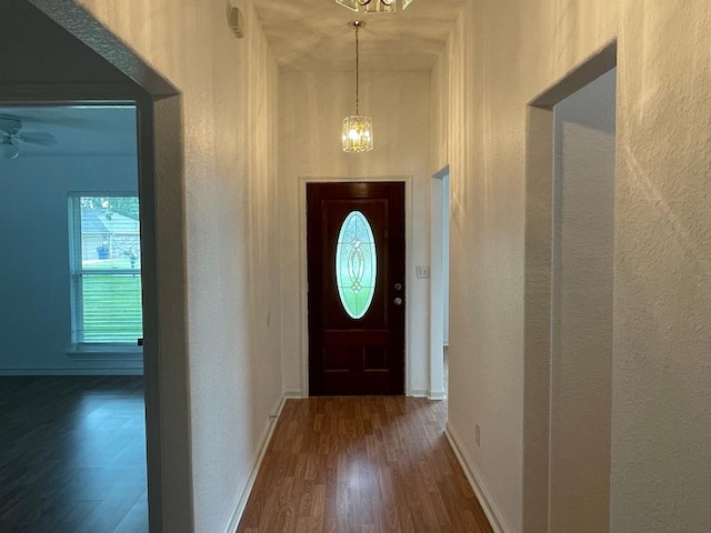 foyer with an inviting chandelier and dark hardwood / wood-style floors