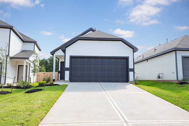 view of front of home with a front yard and a garage