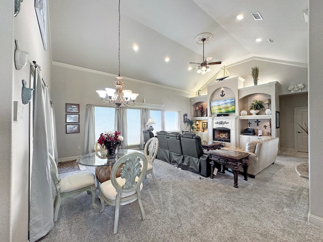 dining area with a warm lit fireplace, visible vents, light colored carpet, high vaulted ceiling, and ceiling fan with notable chandelier