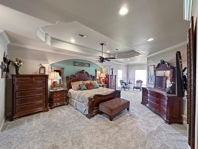 bedroom featuring ornamental molding, carpet, ceiling fan, and a tray ceiling