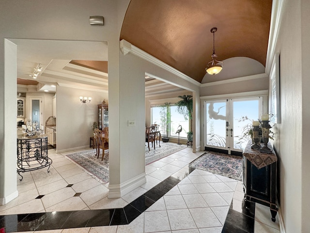 tiled foyer entrance featuring ornamental molding, french doors, and a tray ceiling