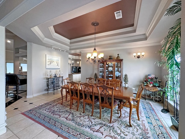 tiled dining room with ornamental molding, a chandelier, plenty of natural light, and a tray ceiling